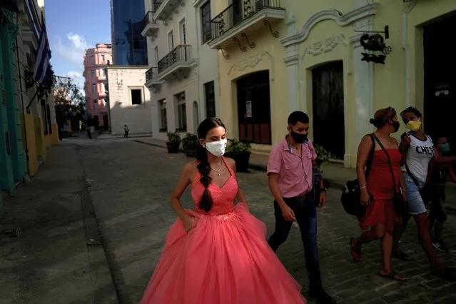 Estefani Linares walks during a photo session for her quinceanera (coming of age of 15-year-olds) celebration amid coronavirus disease (COVID-19) spread concerns, in Havana, Cuba, July 15, 2020. (Photo by Alexandre Meneghini/Reuters)