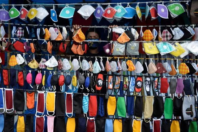 A vendor arranges facemasks to sell on a roadside in Hyderabad on July 28, 2020. (Photo by Noah Seelam/AFP Photo)