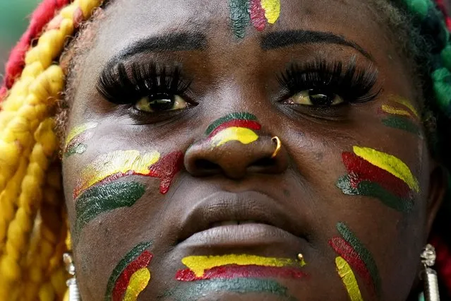 A soccer fan supporting Cameroon, her face painted in the colors of the national flag, waits for the start of the World Cup group G soccer match between Cameroon and Serbia, at the Al Janoub Stadium in Al Wakrah, Qatar, Monday, November 28, 2022. (Photo by Manu Fernandez/AP Photo)