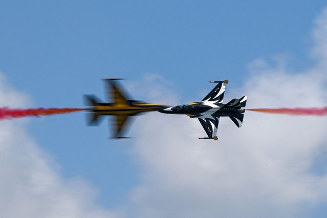 Members of South Korea's “Black Eagle” aerobatics team perform during a preview of the Singapore Airshow in Singapore on February 18, 2024. (Photo by Roslan Rahman/AFP Photo)
