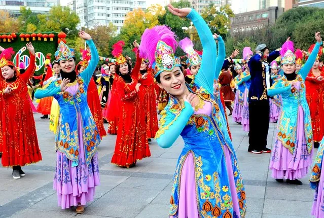 People wearing costumes dance at a square to celebrate the 60th anniversary of the founding of the Xinjiang Uighur Autonomous Region, in Urumqi, Xinjiang Uighur Autonomous Region, October 1, 2015. (Photo by Reuters/Stringer)