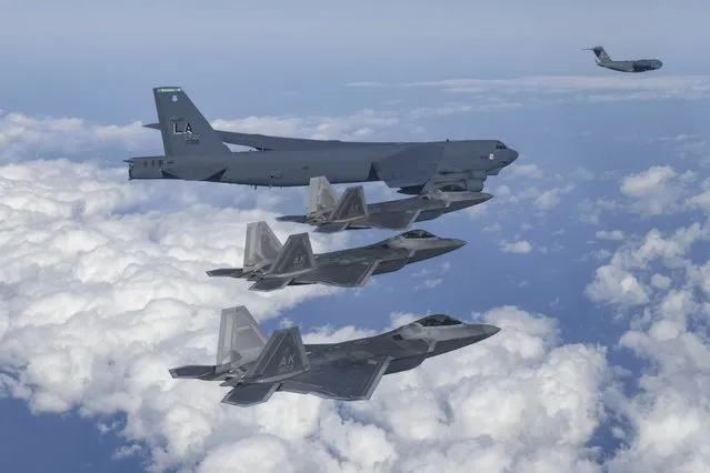 In this photo provided by South Korean Defense Ministry, A U.S. B-52 bomber, C-17 and South Korean Air Force F-35 fighter jets fly over the Korean Peninsula during a joint air drill in South Korea, Tuesday, December 20, 2022. The United States flew nuclear-capable bombers and advanced stealth jets in a show of force against North Korea on Tuesday, as the powerful sister of North Korean leader Kim Jong Un derided doubts about her country's military and threatened a full-range intercontinental ballistic missile test. (Photo by South Korean Defense Ministry via AP Photo)
