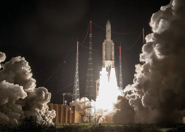A handout photo made available by the European Space Agency (ESA) and French Centre National d'Etudes Spatiales (CNES) on 26 January 2018 shows an Ariane-5 rocket, carrying the SES-14 and Al Yah 3 television and communication satellites and the NASA “Gold” probe, taking off from its launch pad in Kourou, French Guiana, 25 January 2018. Media reports state that there has been technical problems shortly after the launch when the ground control lost contact with the rocket's upper stage. An “Arianespace” operator spokesperson confirmed the contact-loss but was cited as saying that all missions were going on after the payload satellites had been detected in their orbit positions. (Photo by Jm Guillon/EPA/EFE)