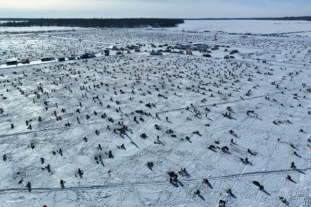 People fish on the frozen Gull Lake during the 2023 Brainerd Jaycees Ice Fishing Extravaganza near Brainerd, Minnesota, U.S. January 28, 2023. (Photo by Drone Base/Reuters)