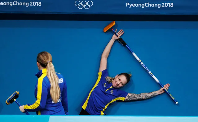 Agnes Knochenhauer and Sofia Mabergs of Sweden stretch before a practice session at the 2018 Winter Olympics in Gangneung, South Korea on February 20, 2018. (Photo by Cathal McNaughton/Reuters)