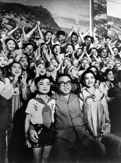 In this July 2, 1978 photo from North Korea's official Korean Central News Agency, distributed by Korea News Service, leader Kim Il Sung is to be part of a souvenir picture after enjoying the music and dance synthesis act by the Pyongyang student art troupe, performed in Japan. (Photo by Korean Central News Agency/Korea News Service via AP Images)