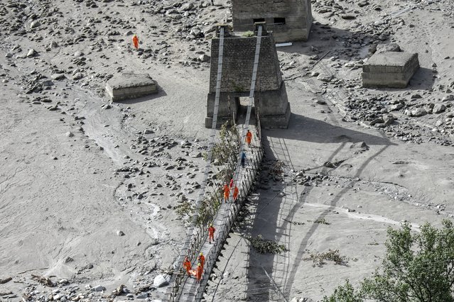 Indian rescue teams work after the cloudburst in Dharali village in Uttarkashi district, Uttarakhand state, northern India, 12 August 2025. Indian authorities confirmed that more than 1,200 people had been rescued in several areas of the Himalayas, after a powerful cloudburst struck the Dharali area in the Uttarkashi district on 05 August, triggering flash floods that swept away a village and left several people dead. (Photo by Rajat Gupta/EPA)