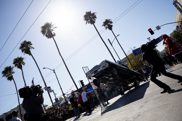 Cameramen film a lowrider taking part in a lowrider hopping competition, in San Francisco, California, U.S., September 20, 2025. (Photo by Manuel Orbegozo/Reuters)