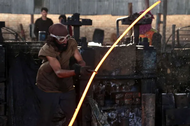 Afghan laborers work at an Iron factory in Jalalabad, Afghanistan, 28 September 2020. Although Afghanistan's economy has reportedly improved, the country still relies heavily on foreign aid, according to official data. (Photo by Ghulamullah Habibi/EPA/EFE)