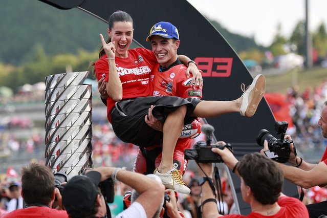 MotoGP Ducati Lenovo Team rider Marc Marquez (R) of Spain and his girlfriend Gemma Pinto (L) celebrate his World Champion 2025 title after the race at the Motorcycling Grand Prix of Japan in Motegi, Tochigi Prefecture, northeastern Japan, 28 September 2025. (Photo by Franck Robichon/EPA)