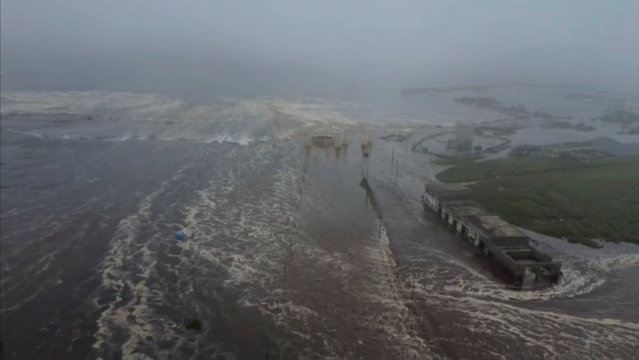 Tsunami waves flood an area after a powerful magnitude 8.8 earthquake struck off Russia's far eastern Kamchatka Peninsula, in Severo-Kurilsk, Sakhalin Region, Russia, on July 30, 2025, in this still image taken from video. (Photo by Kamchatka branch of the Geophysical Survey of the Russian Academy of Sciences/Handout via Reuters)
