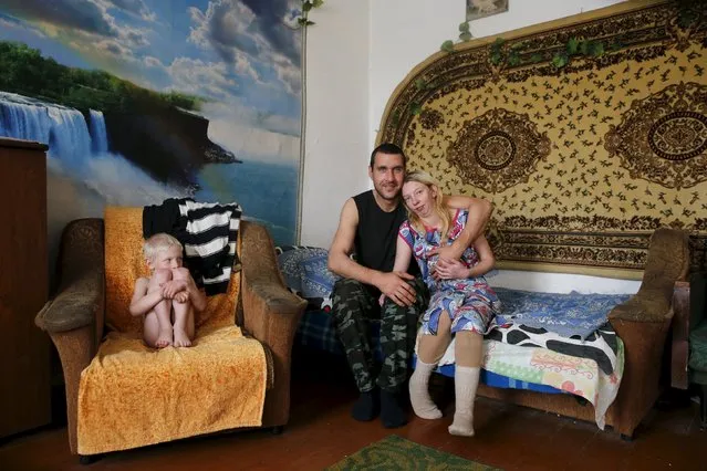 The Jakushin family (L-R) Egor, Alexey and Lena, pose for a picture in their home in Sankin, Sverdlovsk region, October 18, 2015. (Photo by Maxim Zmeyev/Reuters)