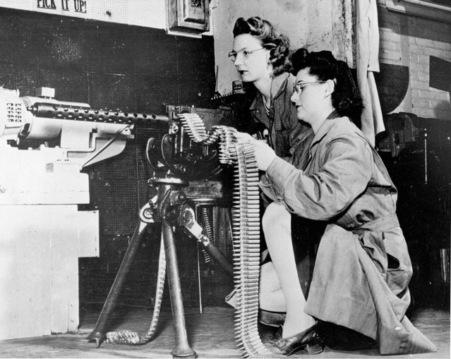 Mae Zelinsky, left, and Betty O'Beda test ammunition on a .30 caliber rifle at a Remington Arms plant on April 30, 1943. Many women took over jobs that were left vacant when men went overseas to fight in World War II. (Photo by AP Photo)