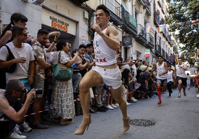 Participants compete in the High-Heels Race as part of the Pride celebrations, in the Chueca neighbourhood in Madrid on July 4 29, 2024. MADO (Madrid Pride) is a series of street celebrations that take place during the city´s LGBTIQ (lesbian, gay, bisеxual, transgender, intersеx and queer) Pride week. (Photo by Óscar del Pozo/AFP Photo)