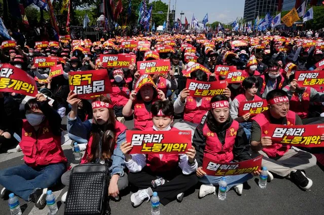 Members of Federation of Korean Trade Unions holds up their signs during a rally on May Day in Seoul, South Korea, Monday, May 1, 2023. A large number of workers and activists in Asian countries were marking May Day on Monday with protests calling for higher salaries, reduced working hours and other better working conditions. The signs read “Stop labor deterioration!”. (Photo by Ahn Young-joon/AP Photo)