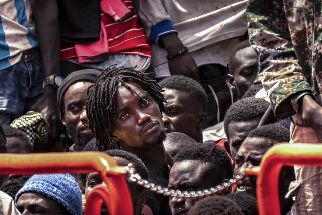 Migrants wait to disembark from a crowded boat after a thirteen-day voyage from the coast of Senegal, at La Estaca port in El Hierro, Spain, August 26, 2024. (Photo by Maria Ximena/AP Photo)