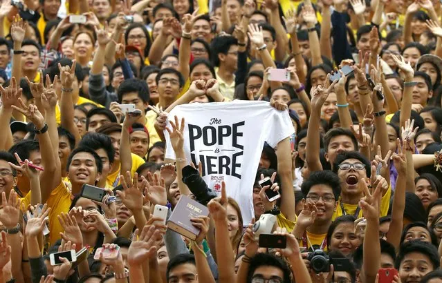 Youths cheer as Pope Francis arrives for a meeting with young people at Manila university, January 18, 2015. (Photo by Stefano Rellandini/Reuters)