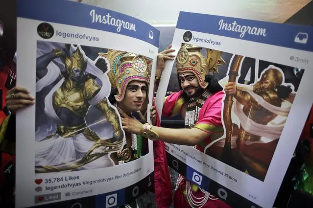Fans dressed as Hindu mythological characters pose for photographs at Delhi Comic Con in New Delhi, India, Saturday, December 5, 2015. Indian mythological heroes, dressed in gaudy costumes with bejeweled crowns and sparkly clothes, added to the carnival atmosphere of India's annual comic book fest Saturday, ready to oblige fans with an autograph, a selfie or a photograph. (Photo by Altaf Qadri/AP Photo)