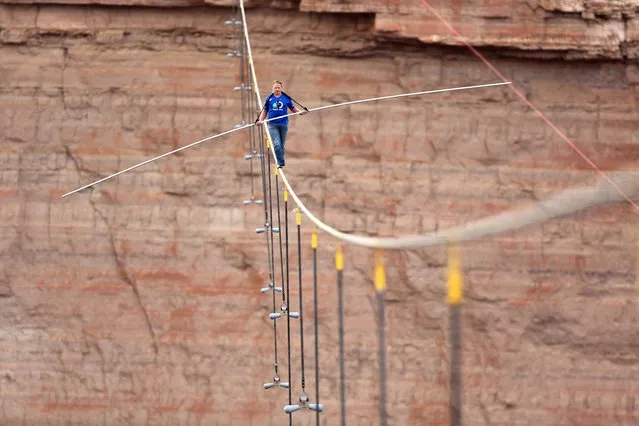 Nik Wallenda walks across a 2-inch wire 1500 feet above the ground to cross the Grand Canyon for Skywire Live With Nik Wallenda on the Discovery Channel, Sunday, June 23, 2013 at the Grand Canyon, Calif. (Photo by Tiffany Brown/AP Images for Discovery Communications)