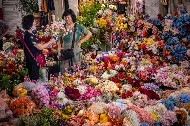 People shop for Lunar New Year decoration items at the Spring Festival Fair in the Old Quarter on January 14, 2023 in Hanoi, Vietnam. (Photo by Linh Pham/Getty Images)