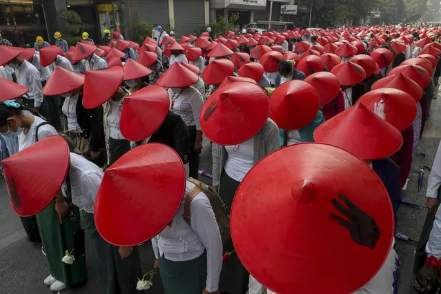 Anti-coup school teachers in their uniform and traditional Myanmar-hats participate in a demonstration in Mandalay, Myanmar, Wednesday, March 3, 2021. Demonstrators in Myanmar took to the streets again on Wednesday to protest last month's seizure of power by the military. (Photo by AP Photo/Stringer)