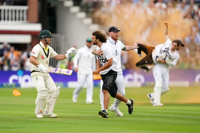 England's Ben Stokes (centre) grabs a Just Stop Oil protestor whilst Johnny Bairstow (right) carries another protester off the field during day one of the second Ashes test match at Lord's, London on Wednesday, June 28, 2023. (Photo by Mike Egerton/PA Images via Getty Images)