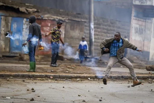 A man kicks a tear gas grenade back towards police during protests in the capital Nairobi, Kenya Friday, July 7, 2023. (Phoot by Brian Inganga/AP Photo)