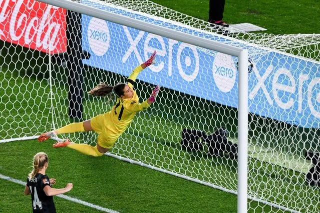 New Zealand's goalkeeper #21 Victoria Esson makes a dive for the ball during the Australia and New Zealand 2023 Women's World Cup Group A football match between New Zealand and Norway at Eden Park in Auckland on July 20, 2023. (Photo by Saeed Khan/AFP Photo)