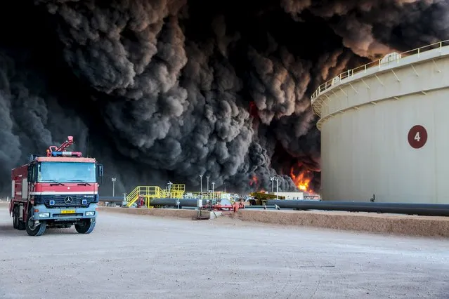 Fire rises from an oil tank in the port of Es Sider, in Ras Lanuf, Libya, January 6, 2016. (Photo by Reuters/Stringer)