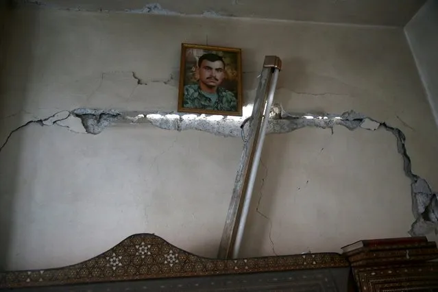 A picture is hung on a damaged wall in a site hit by what activists said were airstrikes carried out by the Russian air force in the town of Douma, eastern Ghouta in Damascus, Syria January 10, 2016. (Photo by Bassam Khabieh/Reuters)