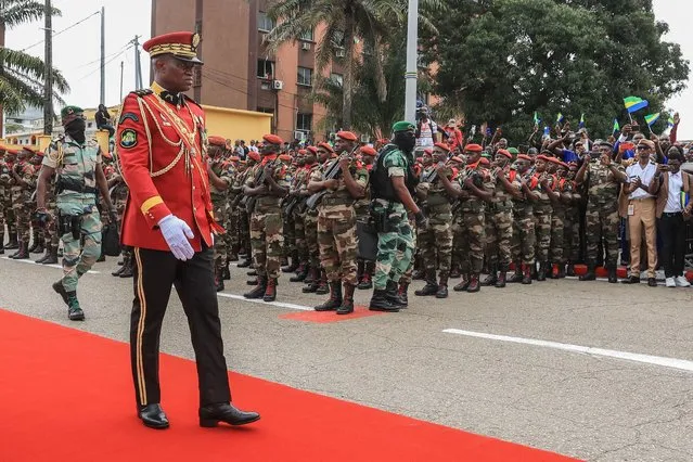Gabon's new strongman General Brice Oligui Nguema (2nd L), who was inaugurated as Gabon's interim President, reviews the troops before the military parade, in Libreville on September 4, 2023. Gabon's coup leader vowed after being sworn in as interim president on September 4, 2023 to restore civilian rule through “free, transparent and credible elections” after a transition and amnesty prisoners of conscience. (Photo by AFP Photo/Stringer)