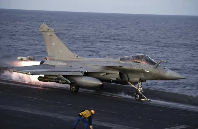 A French Rafale fighter jet takes off from the flight deck of the Charles-de-Gaulle aircraft carrier operating in the eastern Mediterranean Sea on December 9, 2016. (Photo by Stephane De Sakutin/Reuters)