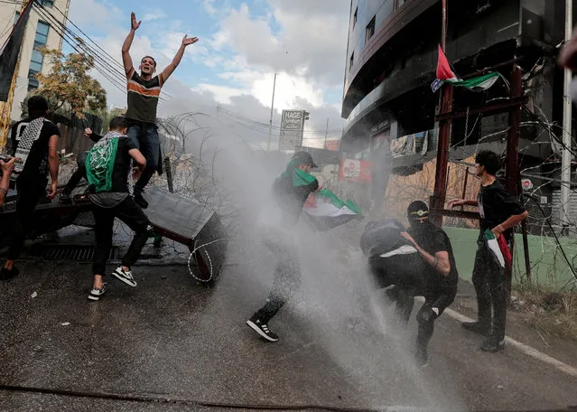 People clash with security forces during a protest in support of Palestinians, near the U.S. embassy in Awkar, after hundreds of Palestinians were killed in a blast at Al-Ahli hospital in Gaza that Israeli and Palestinian officials blamed on each other, Lebanon on October 18, 2023. (Photo by Zohra Bensemra/Reuters)