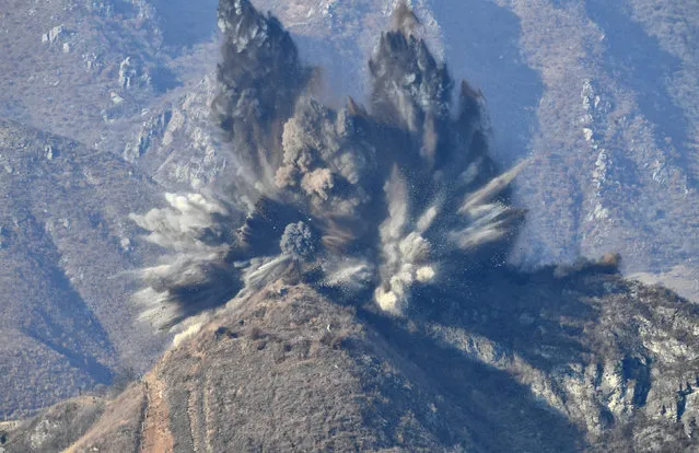 A North Korea's guard post in the demilitarized zone is blown up in this picture taken from South Korea's territory, November 20, 2018. (Photo by The Defense Ministry/Yonhap via Reuters)