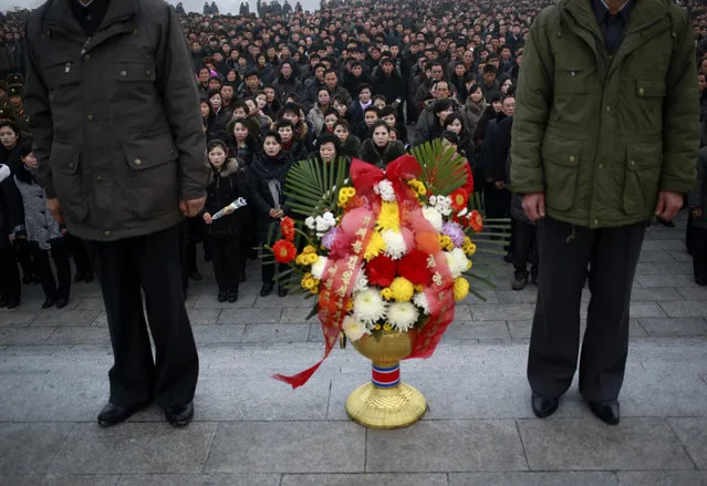 In this Monday, December 17, 2018, file photo, North Koreans wait for their turn to lay flowers at the bronze statues of their late leaders Kim Il Sung and Kim Jong Il at Mansu Hill Grand Monument in Pyongyang, North Korea. North Koreans marked the seventh anniversary of the death of leader Kim Jong Il with visits to statues and vows of loyalty to his son and successor, Kim Jong Un. (Photo by Dita Alangkara/AP Photo)
