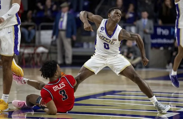 James Madison guard Xavier Brown (0) celebrates after forcing a jump ball against Radford guard Kenyon Giles (3) during the second half of an NCAA college basketball game in Harrisonburg, Va., Friday, November 17, 2023. (Photo by Daniel Lin/Daily News-Record via AP Photo)
