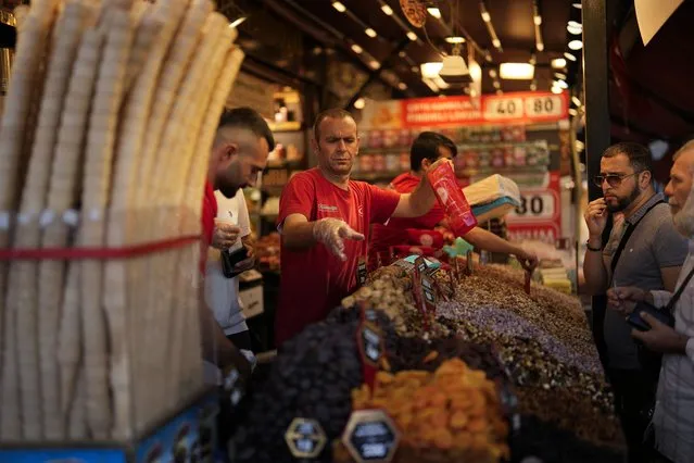 Food shop sellers attend clients in a street market at Eminonu commercial district in Istanbul, Turkey, Wednesday, September 6, 2023. Turkish President Recep Tayyip Erdogan, who has espoused unconventional policies in the past, is fully on board with the country's new economic policies that foresee a tight monetary policy to bring down inflation, members of his economy team said Thursday. (Photo by Francisco Seco/AP Photo)