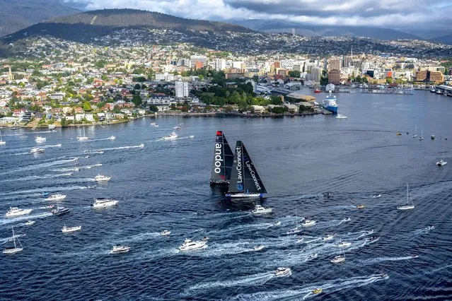 This handout image received from Rolex on December 28, 2023 shows yachts Law Connect and Andoo Comanche near the finish line of the annual Sydney to Hobart yacht race in Hobart. (Photo by Andrea Francolini/AFP Photo)