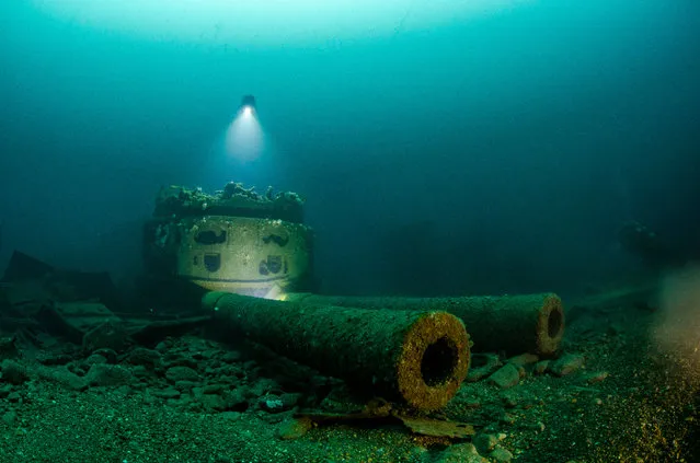 Wrecks category winner. Big Guns by René B. Andersen (Denmark) off Malin Head, Ireland. “HMS Audacious, which lies at 64 metres off Malin Head, was a dreadnought battleship which struck a mine in 1914. After she capsized, the shell magazine exploded and she sank. I used a tripod and 3 Big Blue video lights to illuminate the turret with the majestic 13.5-inch guns and myself as the model ... It took some time before achieving this shot and at 64 metres, the clock ticks fast. That is the challenge with deep-wreck photography”. (Photo by Rene’ B Andersen/Underwater Photographer of the Year 2019)