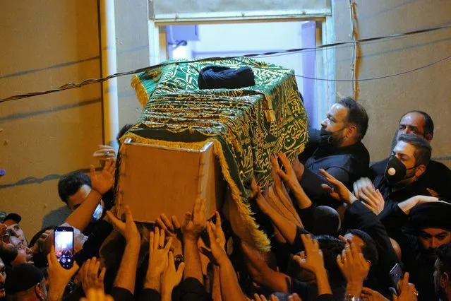 Mourners escort the coffin of Grand Ayatollah Sayyid Mohammed Saeed al-Hakim to his home in Najaf, Iraq, Friday, September 3, 2021. Mohammed Saeed al-Hakim, one of Iraq's most senior and influential Muslim Shiite clerics, has died, members of his family said. He was 85. (Photo by Anmar Khalil/AP Photo)
