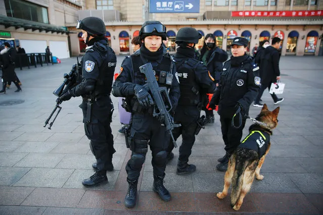 Members of police swat patrol with their dog at the Beijing Railway Station in central Beijing, China January 27, 2017 as China gears up for Lunar New Year, when hundreds of millions of people head home. (Photo by Damir Sagolj/Reuters)