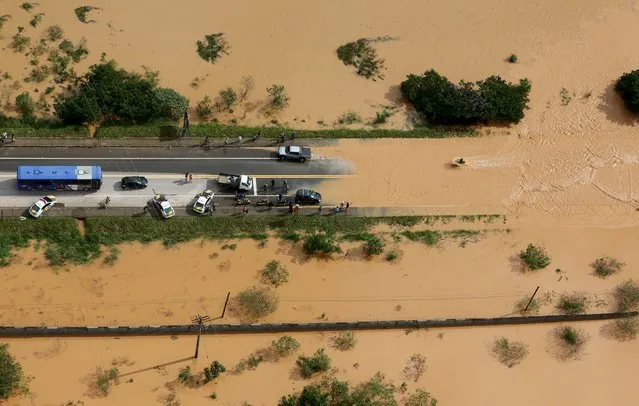 A flooded road is seen in the city of Franco da Rocha, in the north of Sao Paulo state, Brazil, March 11, 2016. (Photo by Paulo Whitaker/Reuters)