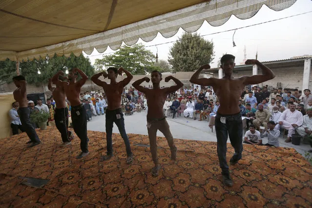 Participants pose during a local bodybuilding and fitness championship in Karachi, Pakistan March 13, 2016. (Photo by Akhtar Soomro/Reuters)