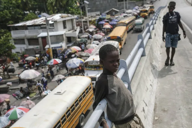 A boy stands on a bridge of a normally busy main road in Port-au-Prince, Haiti, Saturday, October 23, 2021. (Photo by Matias Delacroix/AP Photo)