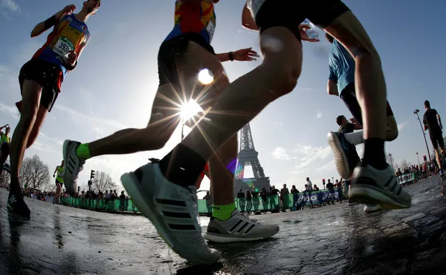 Runners make their way past the Eiffel Tower as they participate in the 42nd Paris Marathon, in France, April 8, 2018. (Photo by Philippe Wojazer/Reuters)