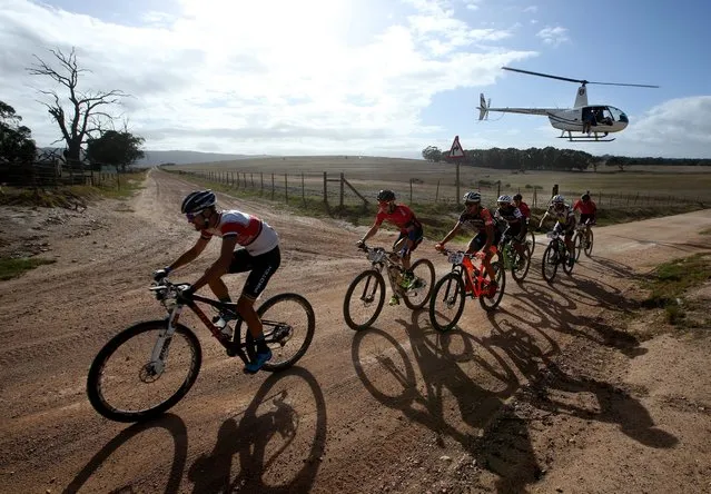 The professional peleton race during the 86km Stage 7 of the 2016 ABSA Cape Epic, Meerendal, South Africa, 20 March 2016.  The ABSA Cape Epic is often described as the “Tour de France” of mountain biking and will see 1200 riders racing over 652km in 8 stages and climbing 15 100m of climbing. UCI professional racers ride alongside amateur riders during the 8 day long race. (Photo by Kim Ludbrook/EPA)