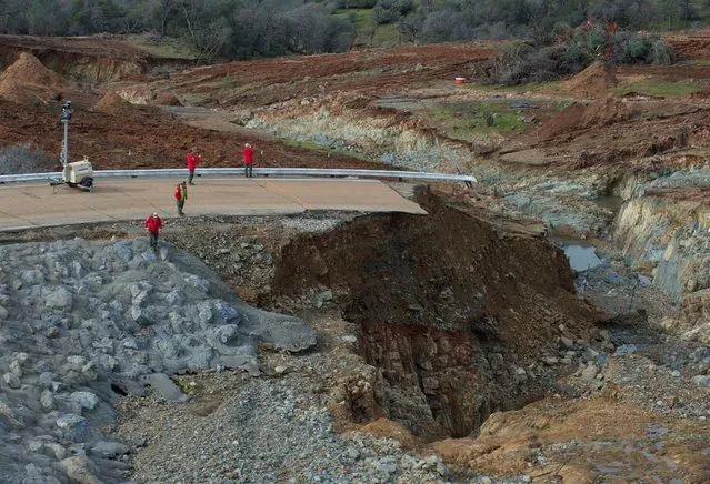 California Department of Water Resources crews inspect and evaluate the erosion just below the Lake Oroville Emergency Spillway site after lake levels receded, in Oroville, California, U.S., February 13, 2017. (Photo by Kelly M. Grow/Reuters/California Department of Water Resources)