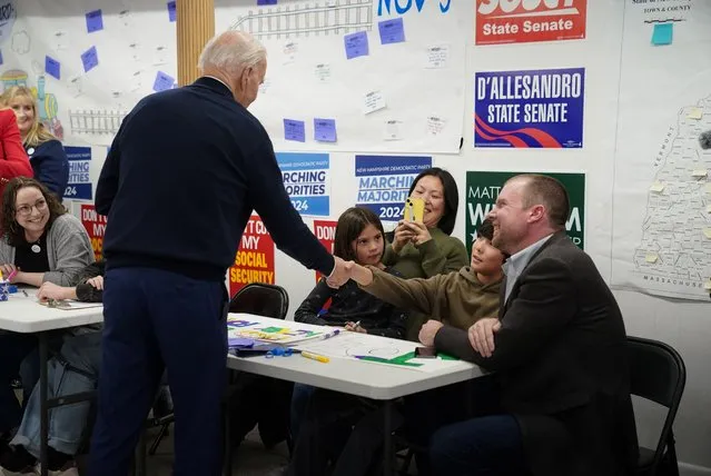 U.S. President Joe Biden greets people during a visit to his campaign field office in Manchester, New Hampshire on March 11, 2024. (Photo by Kevin Lamarque/Reuters)