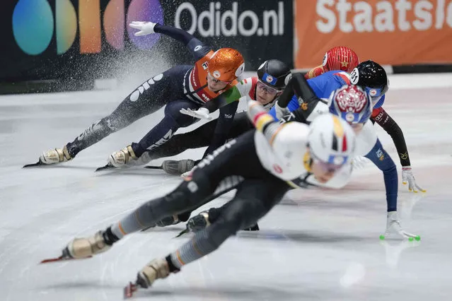 Netherlands' Suzanne Schulting, rear left in orange, crashes with Hungary's Rebeka Sziliczei-Nemet in the women's 1500 meters semi final during the World Championships Short Track skating at Ahoy Arena in Rotterdam, Netherlands, Saturday, March 16, 2024. (Photo by Peter Dejong/AP Photo)