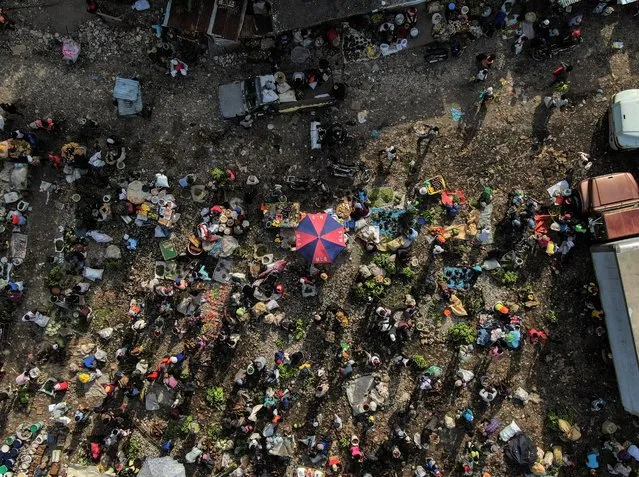 People gather on the first market day since the earthquake in Camp Perrin, Haiti, Friday, August 20, 2021, six days after a 7.2 magnitude quake hit. (Photo by Fernando Llano/AP Photo)